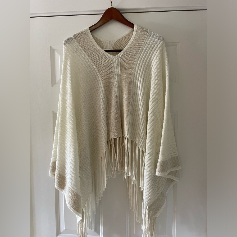 Beautiful knit cape with fringe.